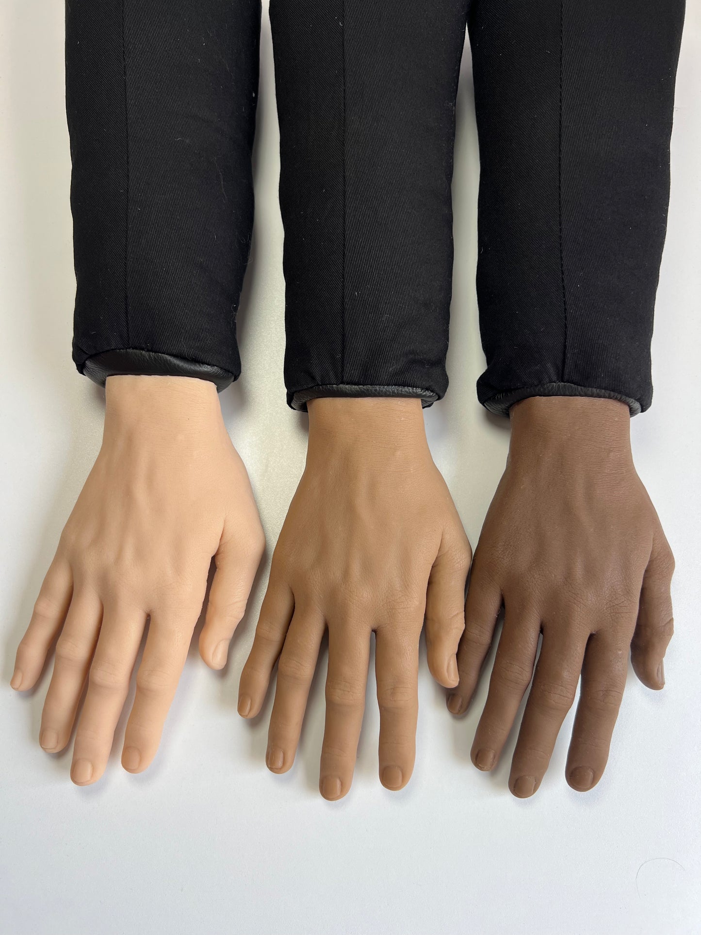 Detachable posable silicone hands for the 2200CC Four Arm Jacket — available in light, medium, and dark skin tones