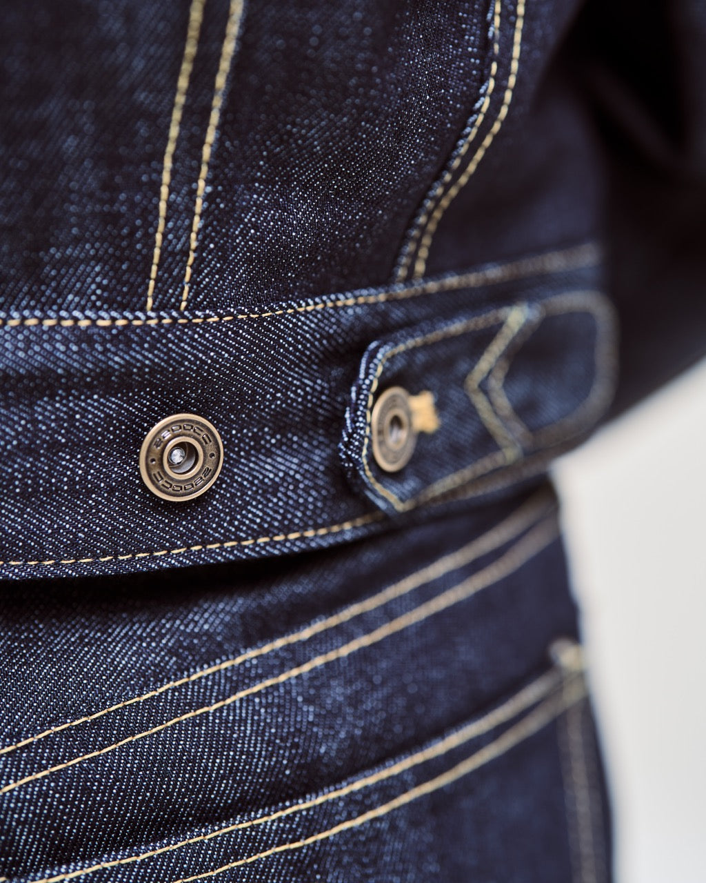 Close-up of blue denim jacket with stitching details
